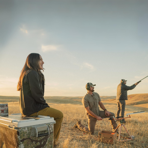 Three friends hunting together and using a Kryptek Obskura camo hard cooler as a seat and meat storage cooler [88 qt] [48 qt]