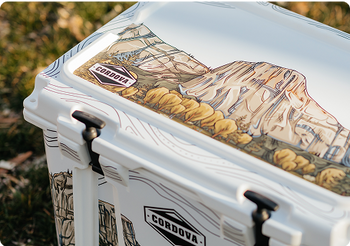 White cooler with mountain design and Cordova logo on a natural background