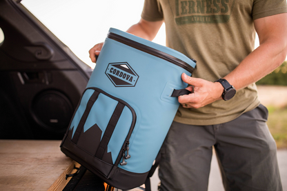 Lightweight blue cooler backpack being easily lifted out of vehicle [Yonder][Scree]